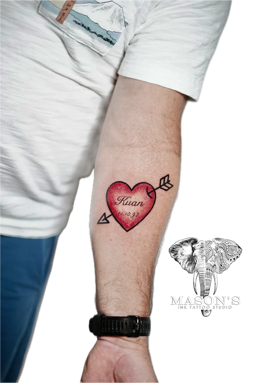 Fine Line Love Script Tattoo Design: a red heart with an arrow and a name and date inside