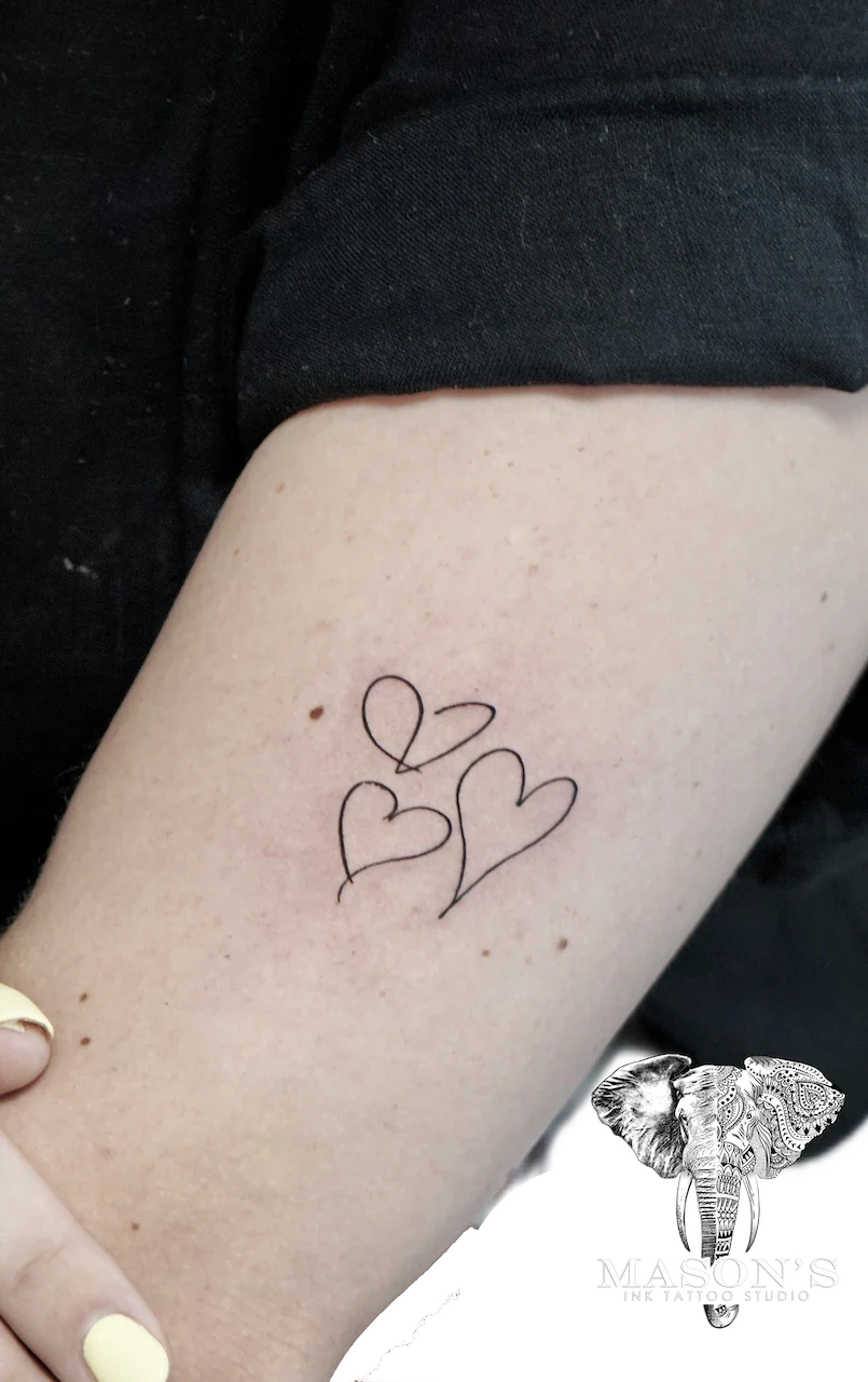 Fine Line Love Tattoo Design: Three hearts with leaves on a forearm