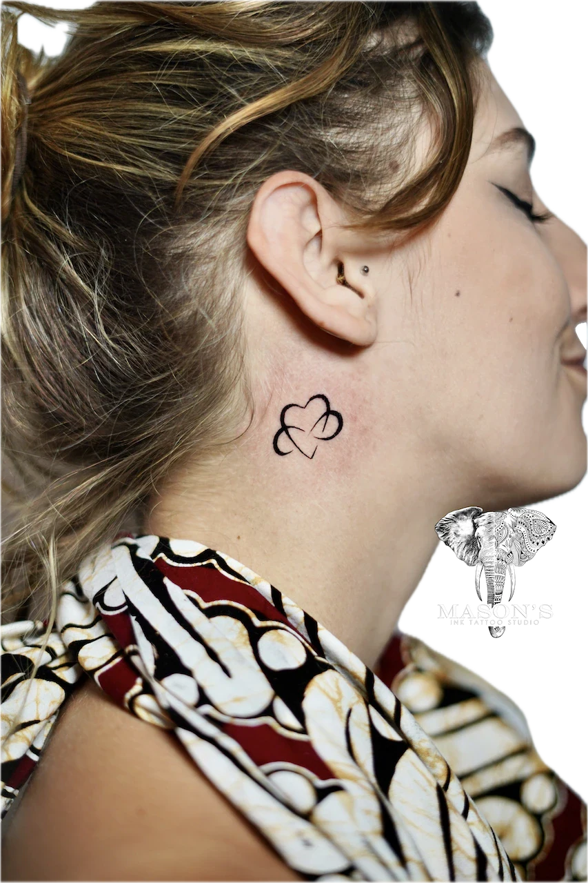 Fine Line Love Tattoo Design: a minimalist clover tattoo behind the ear