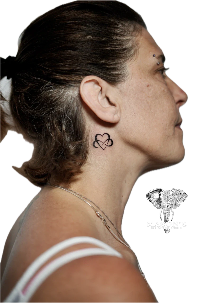 Fine Line Love Tattoo Design: Small heart knot tattoo behind the ear