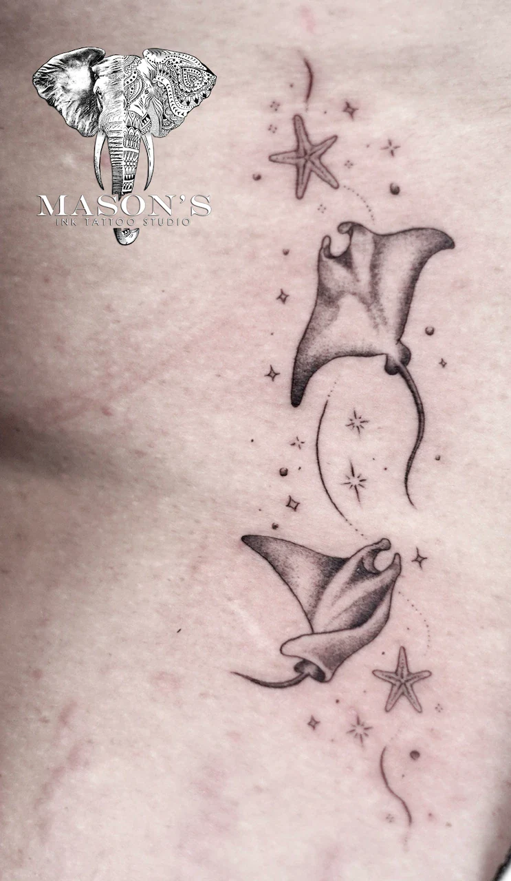 Fine Line Manta Ray Tattoo Design: Two manta rays swimming with stars and starfish in the ocean