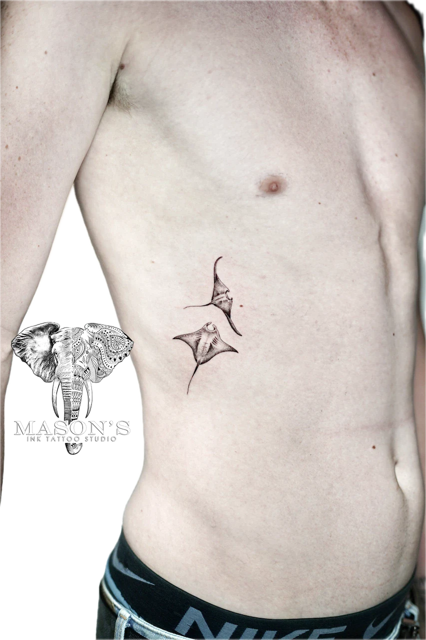Fine Line Manta Ray Tattoo Design: Two small rays on the ribs in black and grey