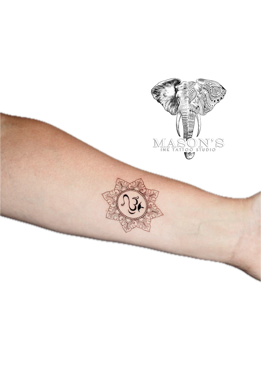 Fine Line Om Symbol Tattoo Design: a small mandala with a spiritual symbol on the forearm