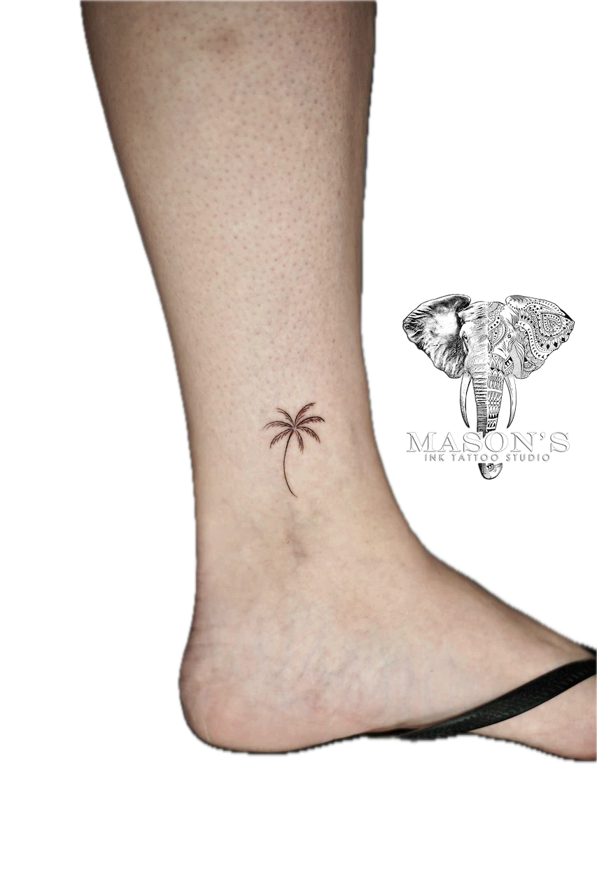 Fine Line Palm Tree Tattoo Design: a small palm tree tattoo on the ankle