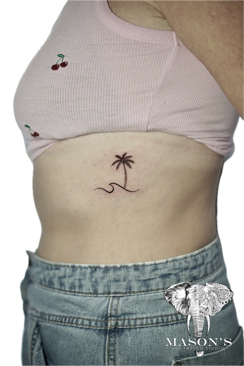 Fine Line Palm Tree and Wave Tattoo Design: Minimalist palm tree and wave tattoo on the stomach