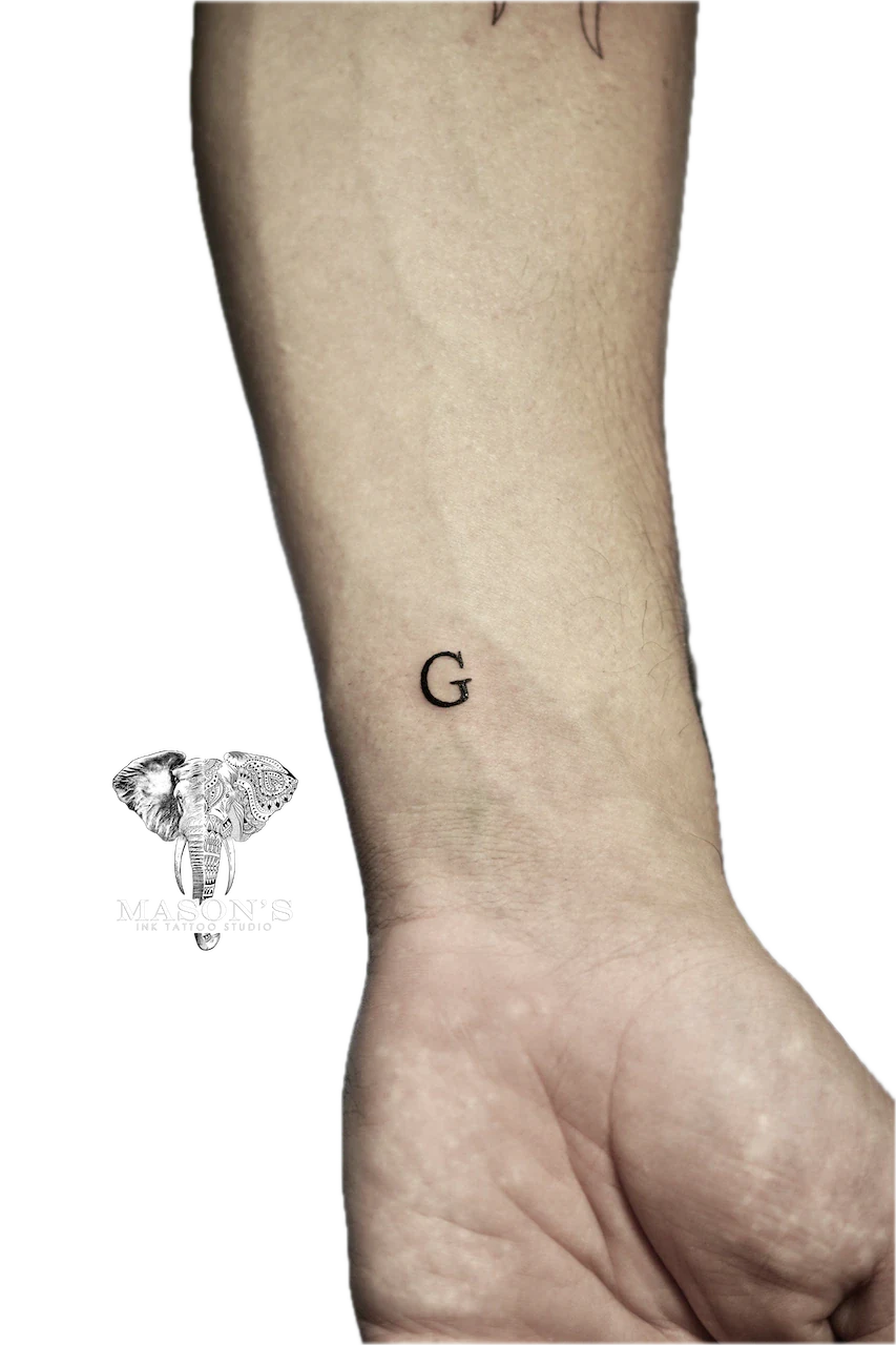Fine Line Script G Tattoo Design by Mason's Ink Tattoo Studio, Bali