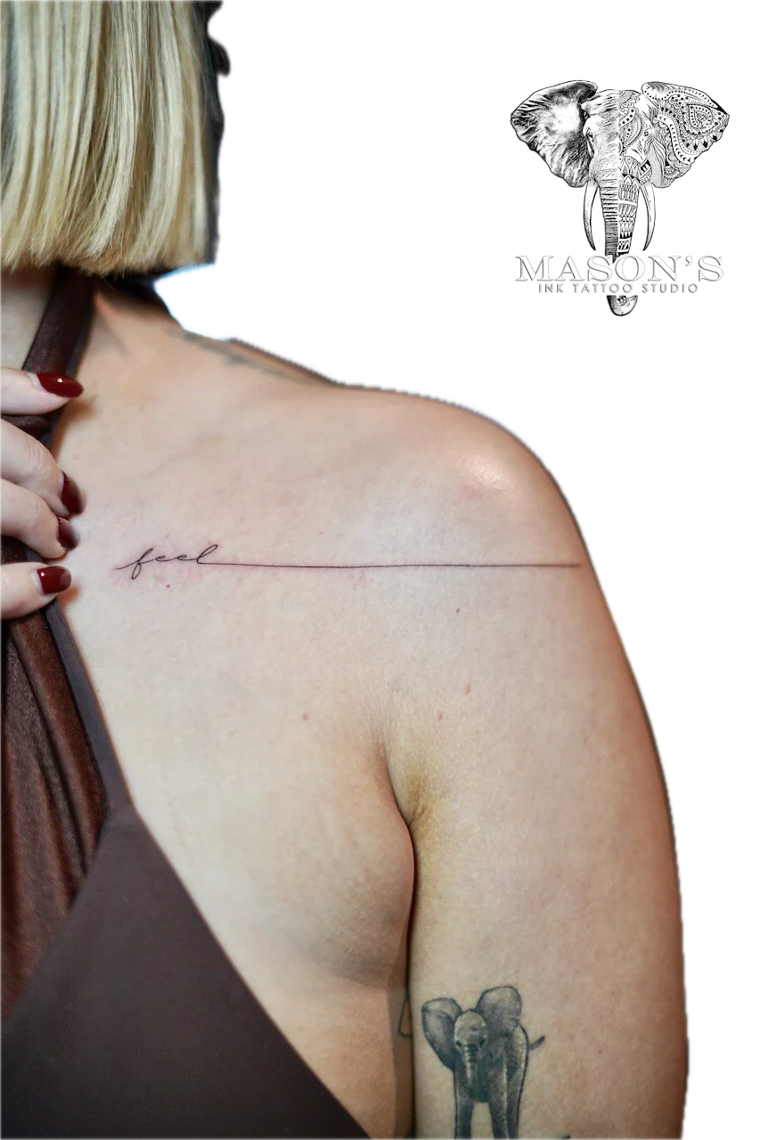 Fine Line Script Lettering Tattoo Design: a small elephant and minimal line lettering on the shoulder