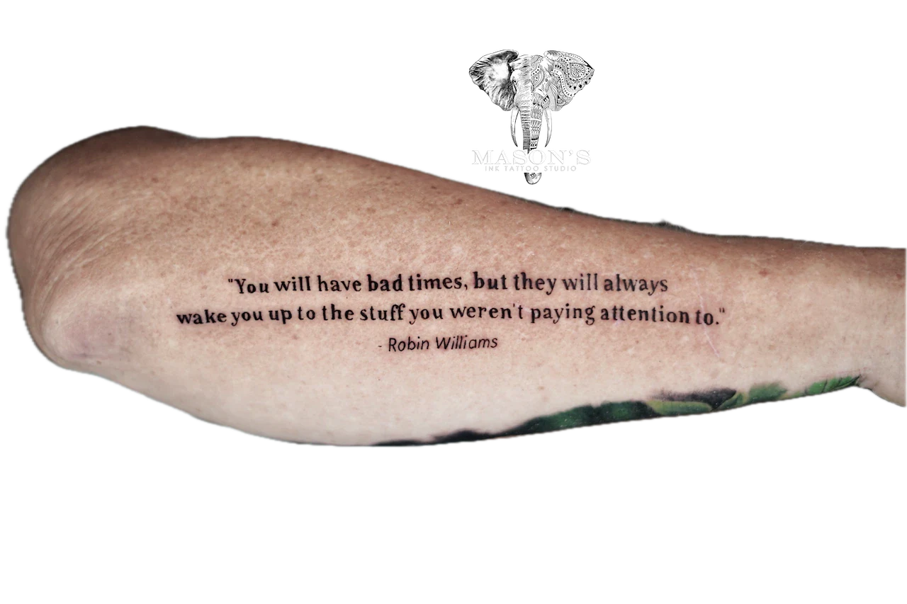 Fine Line Script Tattoo: a quote tattoo with an elephant and tribal pattern on the forearm