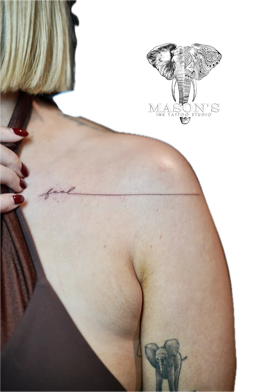 Fine Line Script Tattoo Design: a small elephant and minimal lettering on the shoulder
