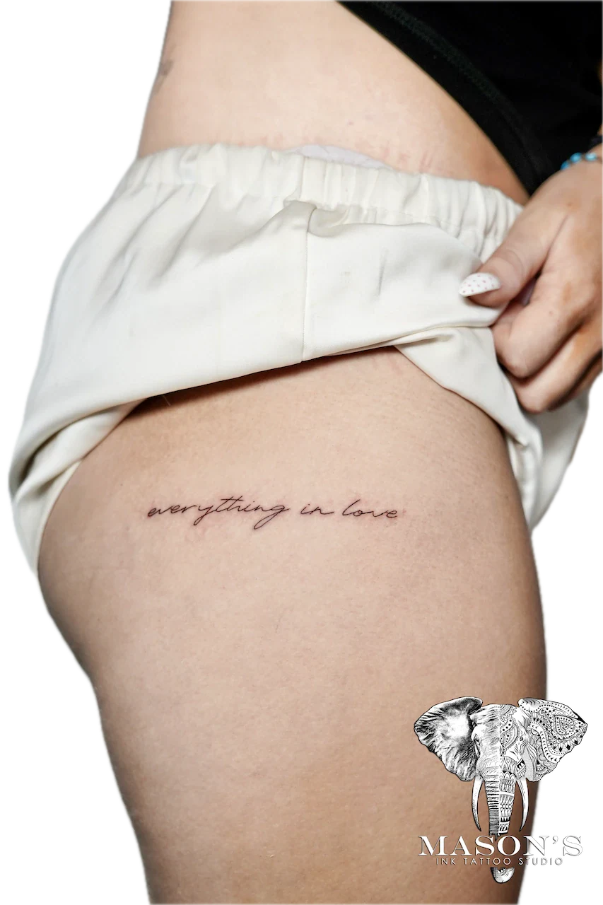 Fine Line Script Tattoo: Small black and grey lettering tattoo on the hip