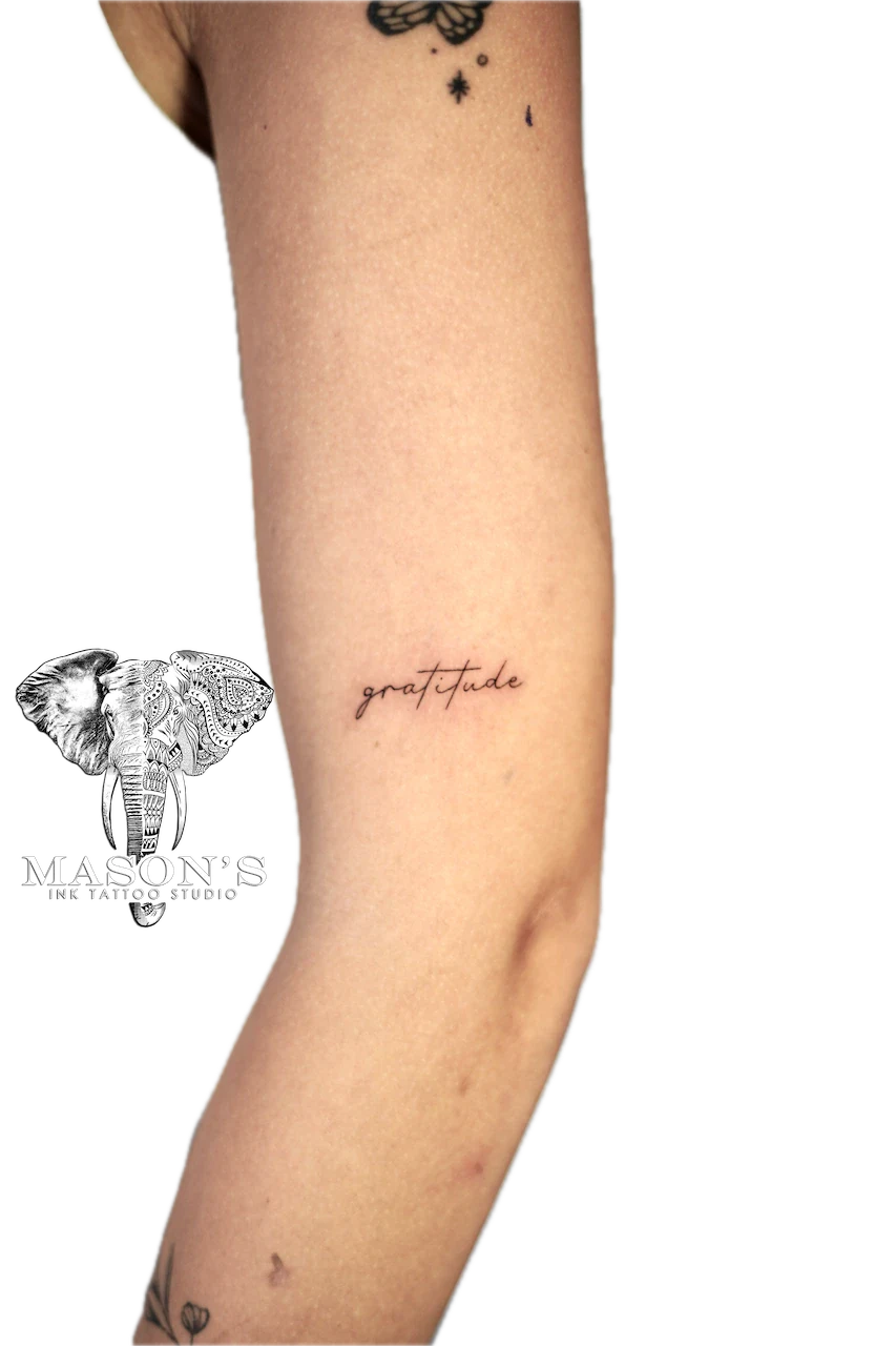 Fine Line Script Tattoo Design: Small forearm tattoo of the word gratitude