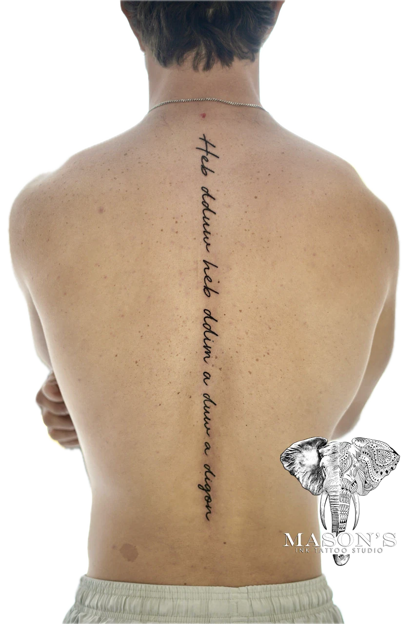 Fine Line Script Tattoo Design: Vertical lettering tattoo on the spine