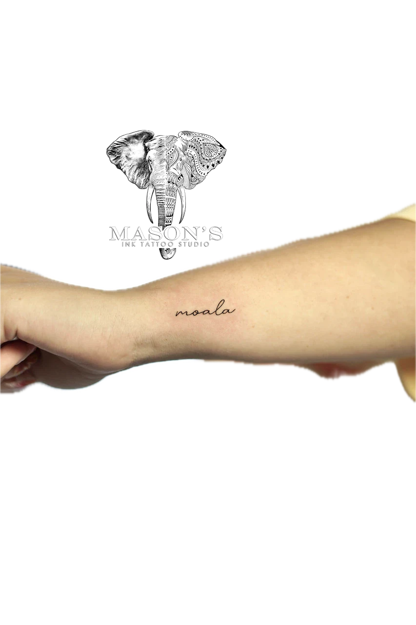 Fine Line Script Tattoo Design: Minimal lettering tattoo on the forearm