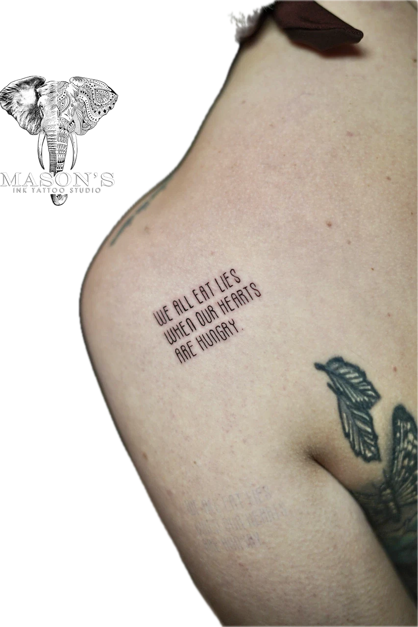 Fine Line Script Tattoo Design: Minimal black and grey lettering with a butterfly on the shoulder