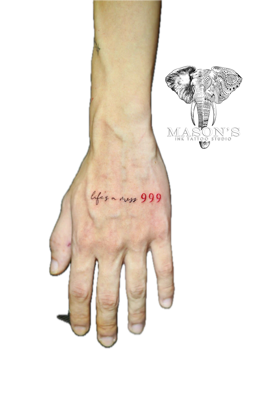 Fine Line Script Tattoo Design: Minimal red lettering and numbers on the back of a hand
