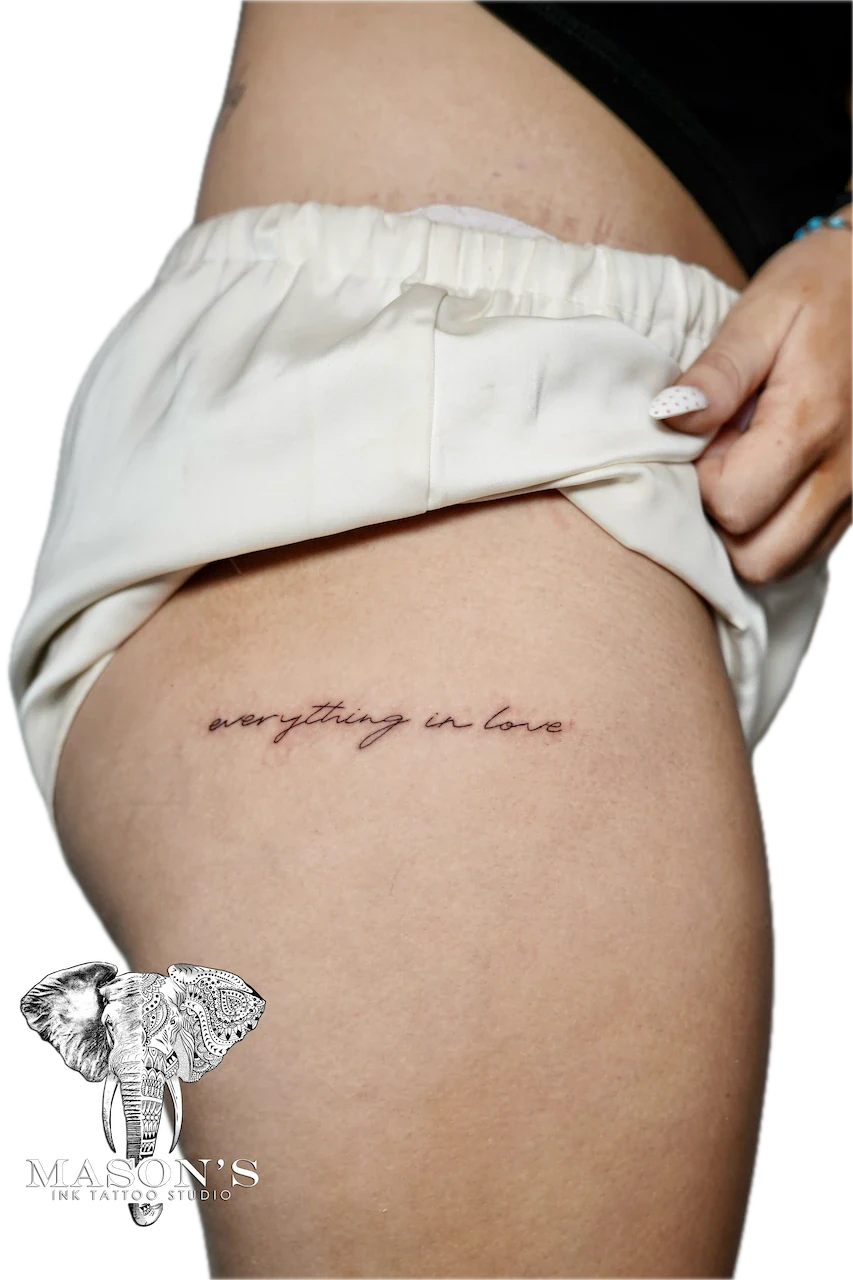 Fine Line Script Tattoo Design: Small love lettering tattoo on the hip
