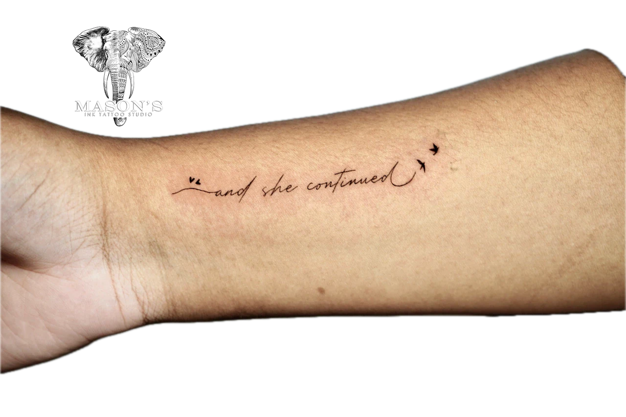 Fine Line Script Tattoo Design: a small forearm tattoo of cursive lettering with an arrow