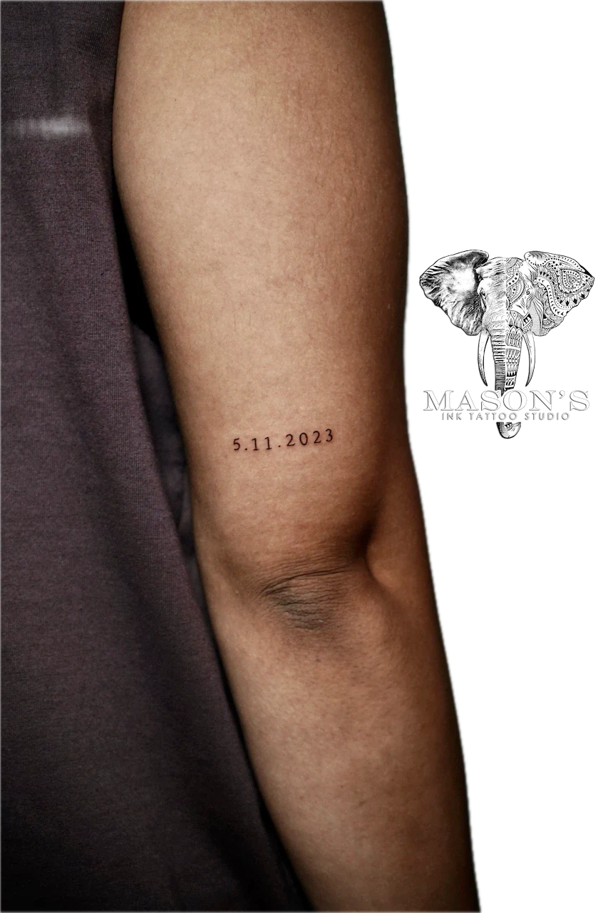 Fine Line Script Tattoo Design: a small date tattoo on the forearm in minimal style