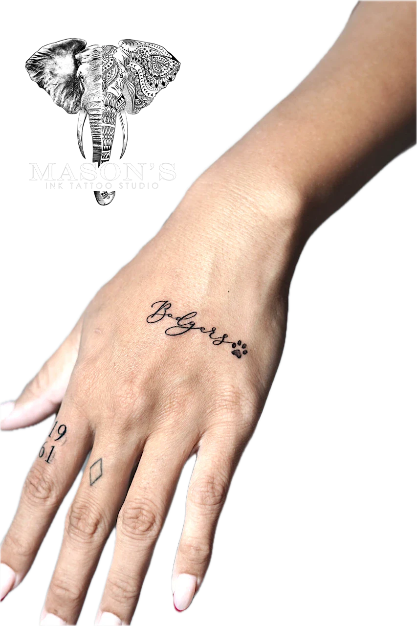 Fine Line Script Tattoo Design: Minimalist hand tattoo with name and paw print