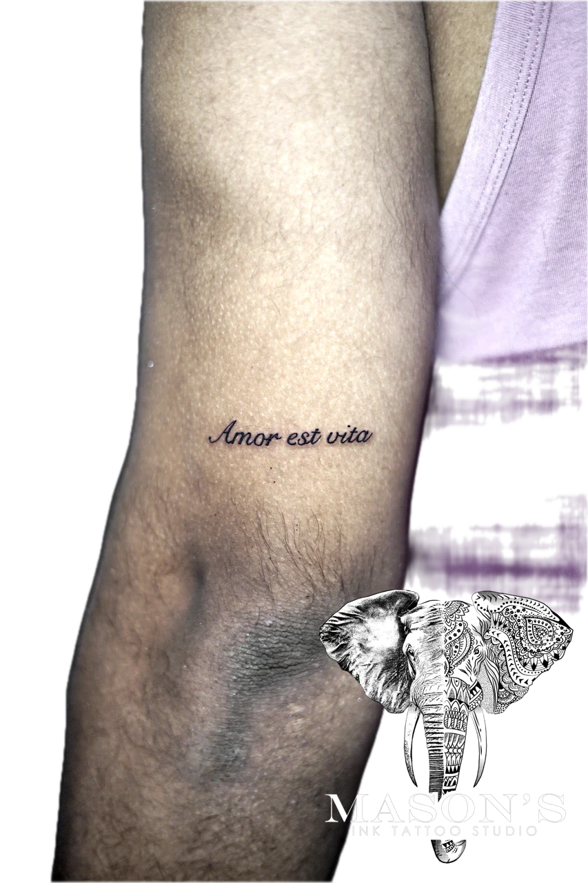 Fine Line Script Tattoo Style amor est vita by Mason's Ink Tattoo Studio, Bali