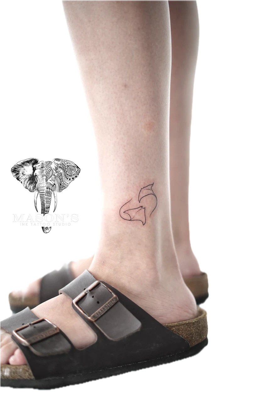 Fine Line Stingray Tattoo Design: a minimalist fish and wave outline tattoo on the ankle