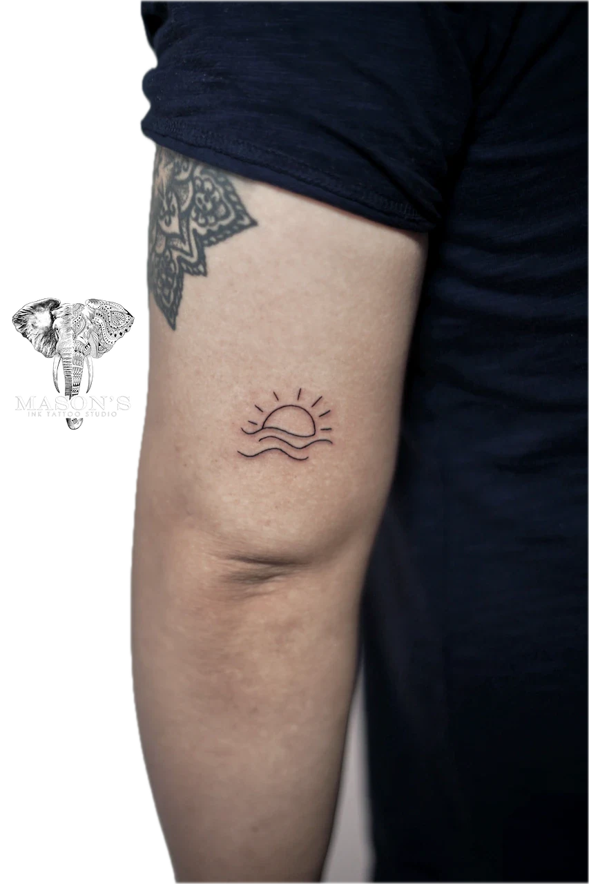 Fine Line Sun and Wave Tattoo Design: a minimal sun and wave tattoo on the thigh