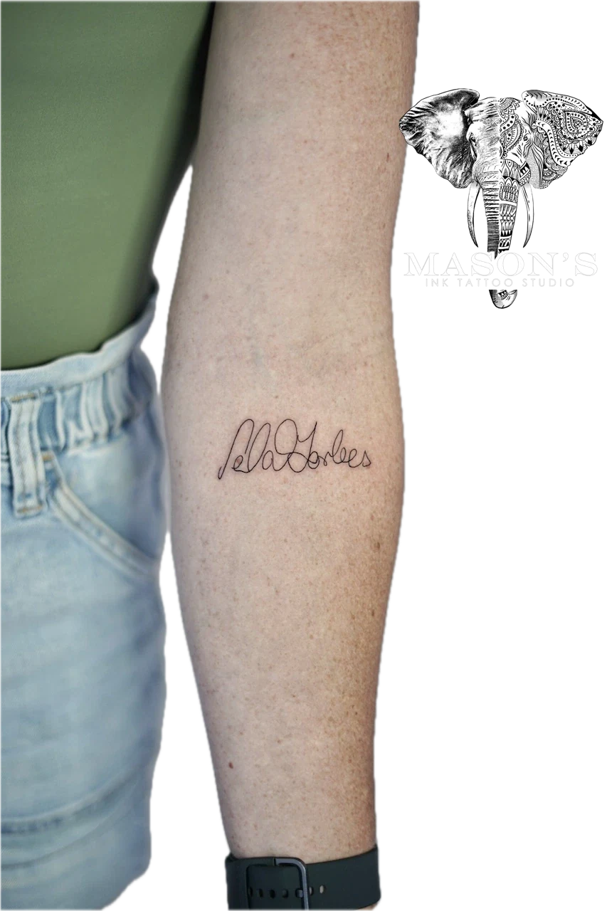 Fine Line Tattoo Design: Small black and grey lettering on the calf