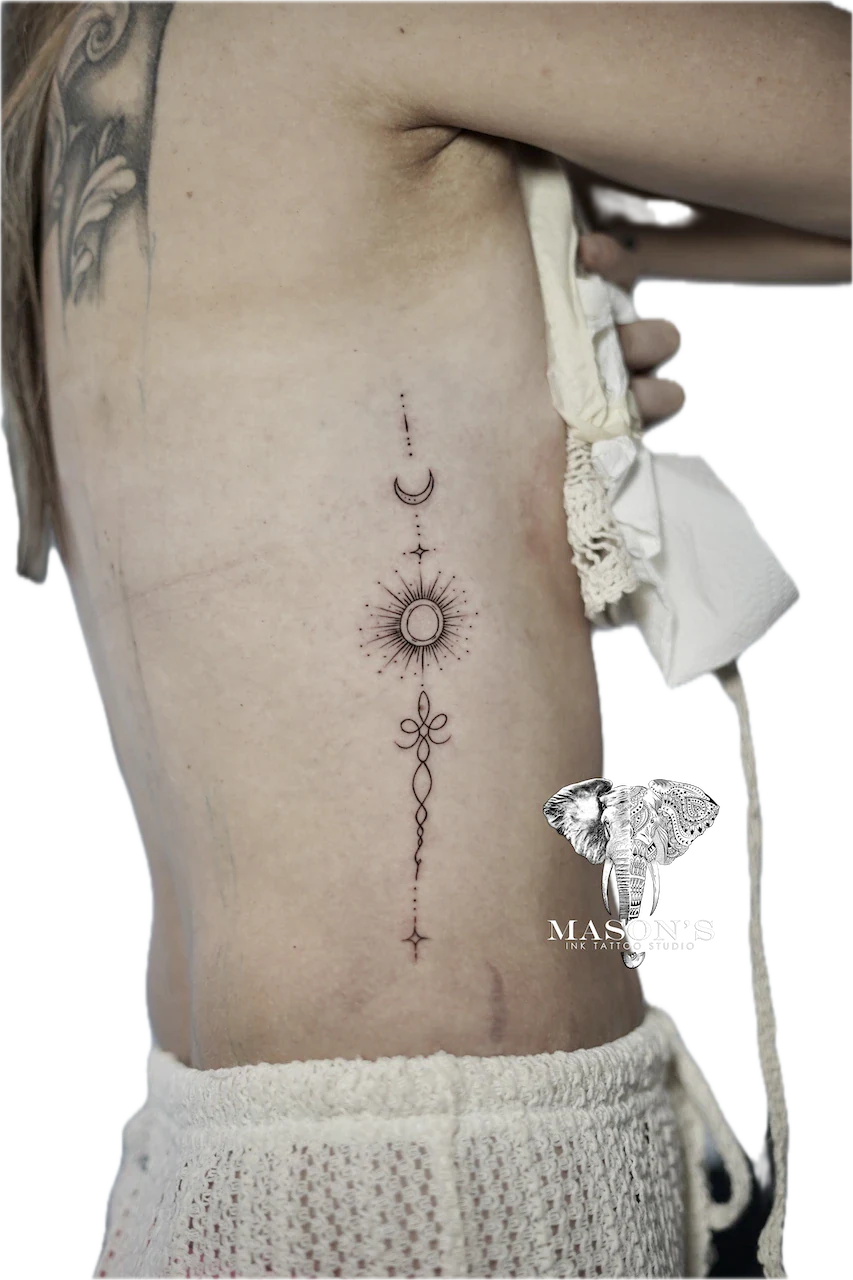 Fine Line Tattoo Design: Minimalist celestial and floral tattoo on the spine