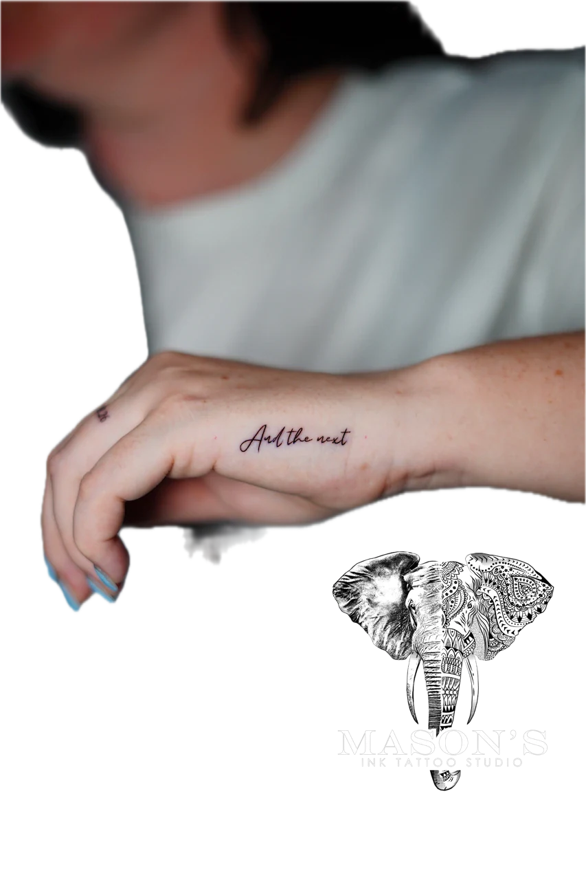 Fine Line Tattoo Style Script: Minimal black and grey lettering on the forearm