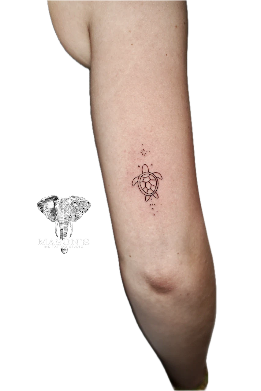 Fine Line Turtle Tattoo Design: a small turtle with stars and dots on the forearm