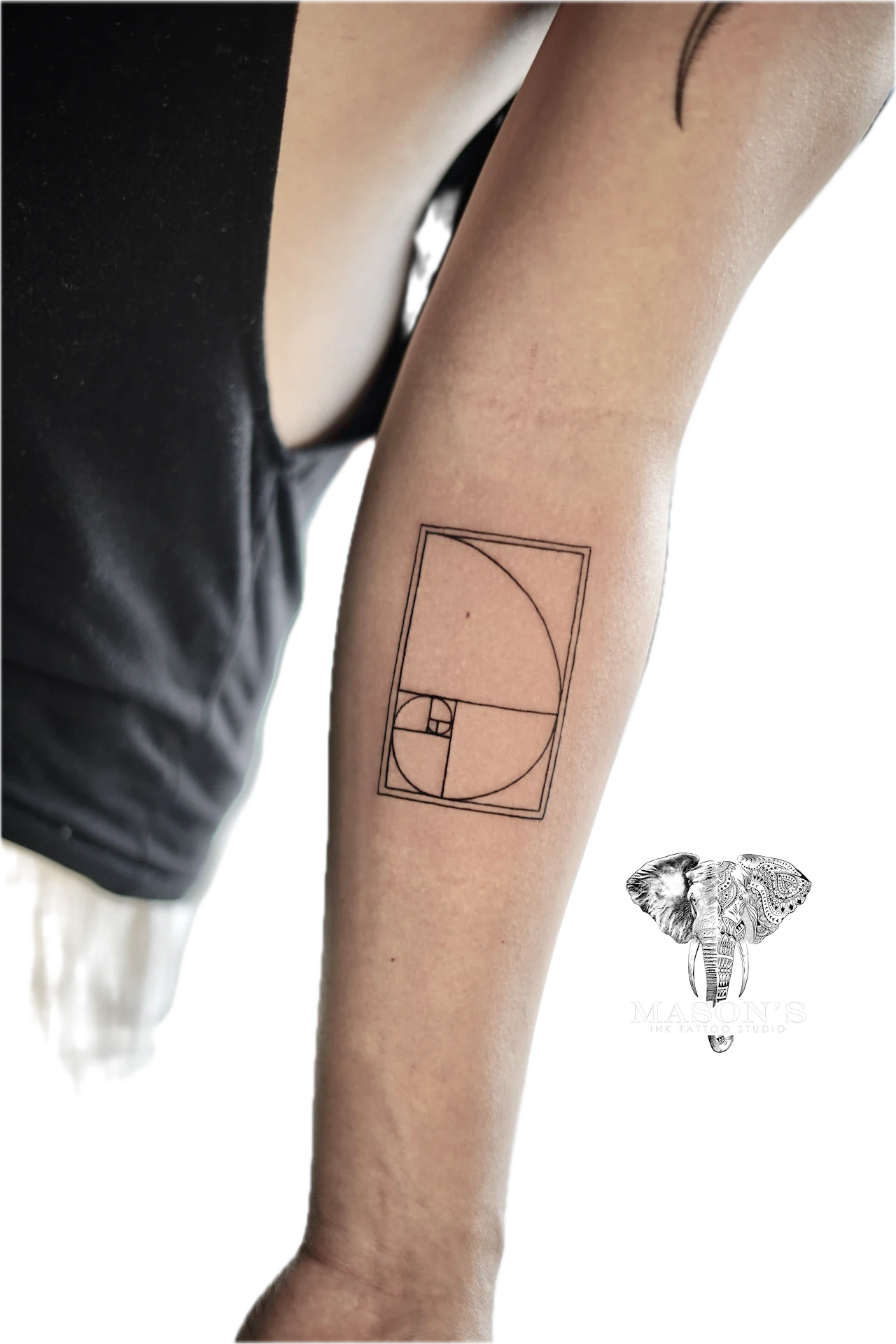 Fine Line Golden Ratio: a small geometric spiral pattern on the forearm