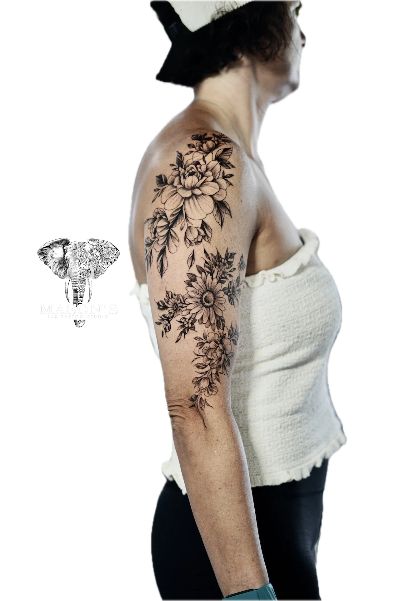 Floral Tattoo Style Design: a large floral tattoo with flowers and leaves on the upper arm