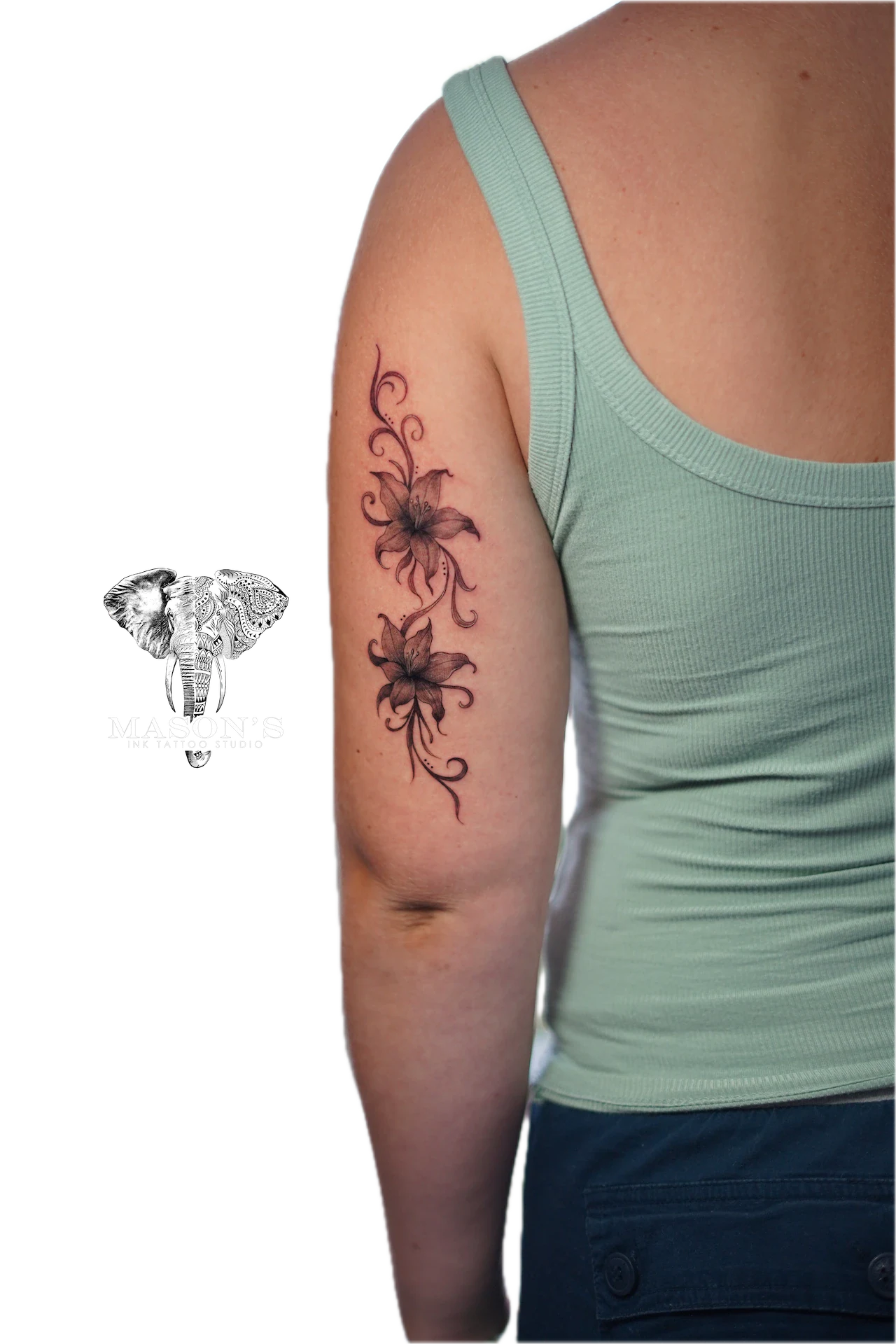 Floral Tattoo Design: Two flowers with vines and swirls on the upper arm