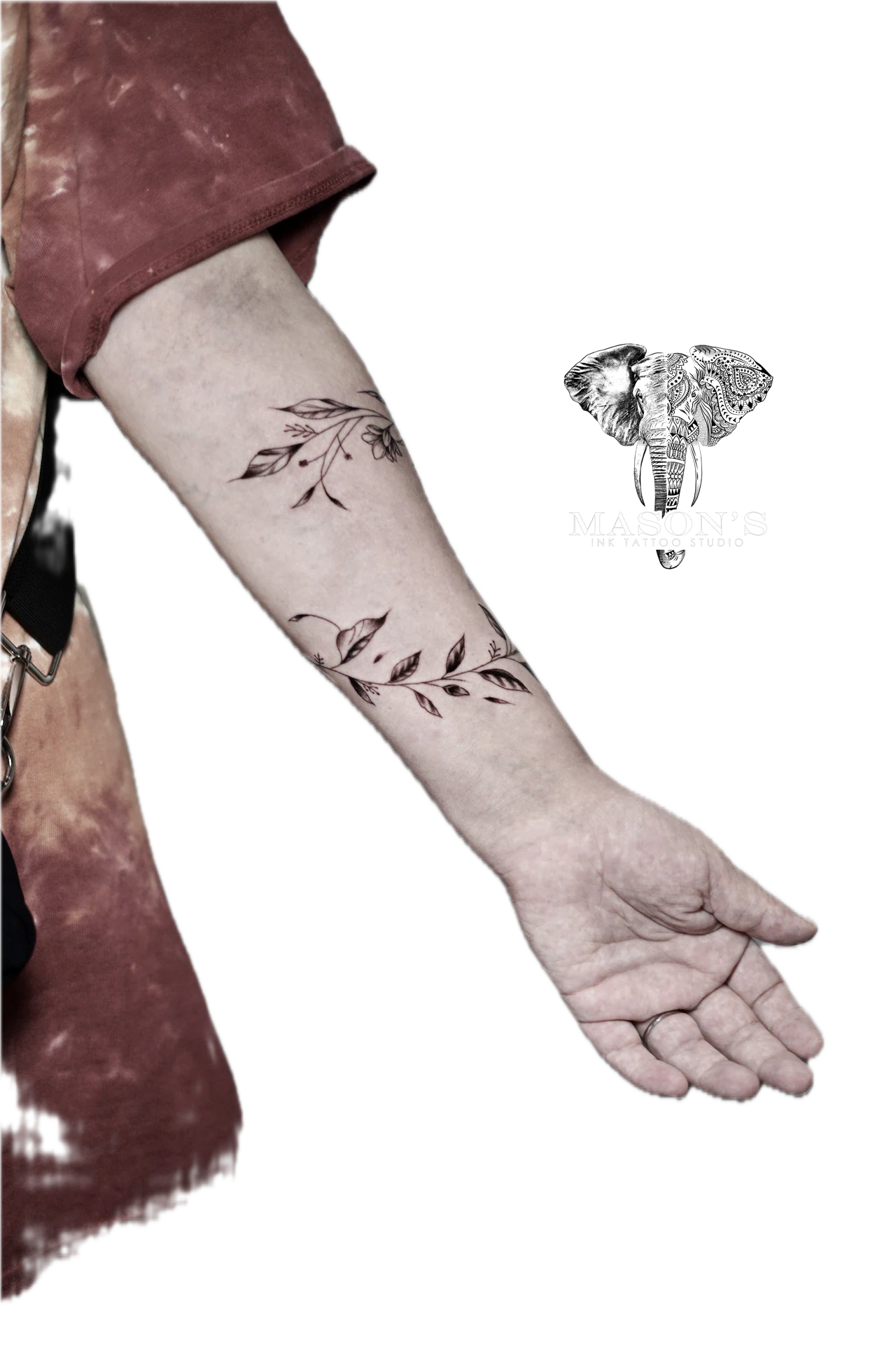 Flower Hand Tattoo Design: a minimal black and grey leaf and vine pattern on the forearm