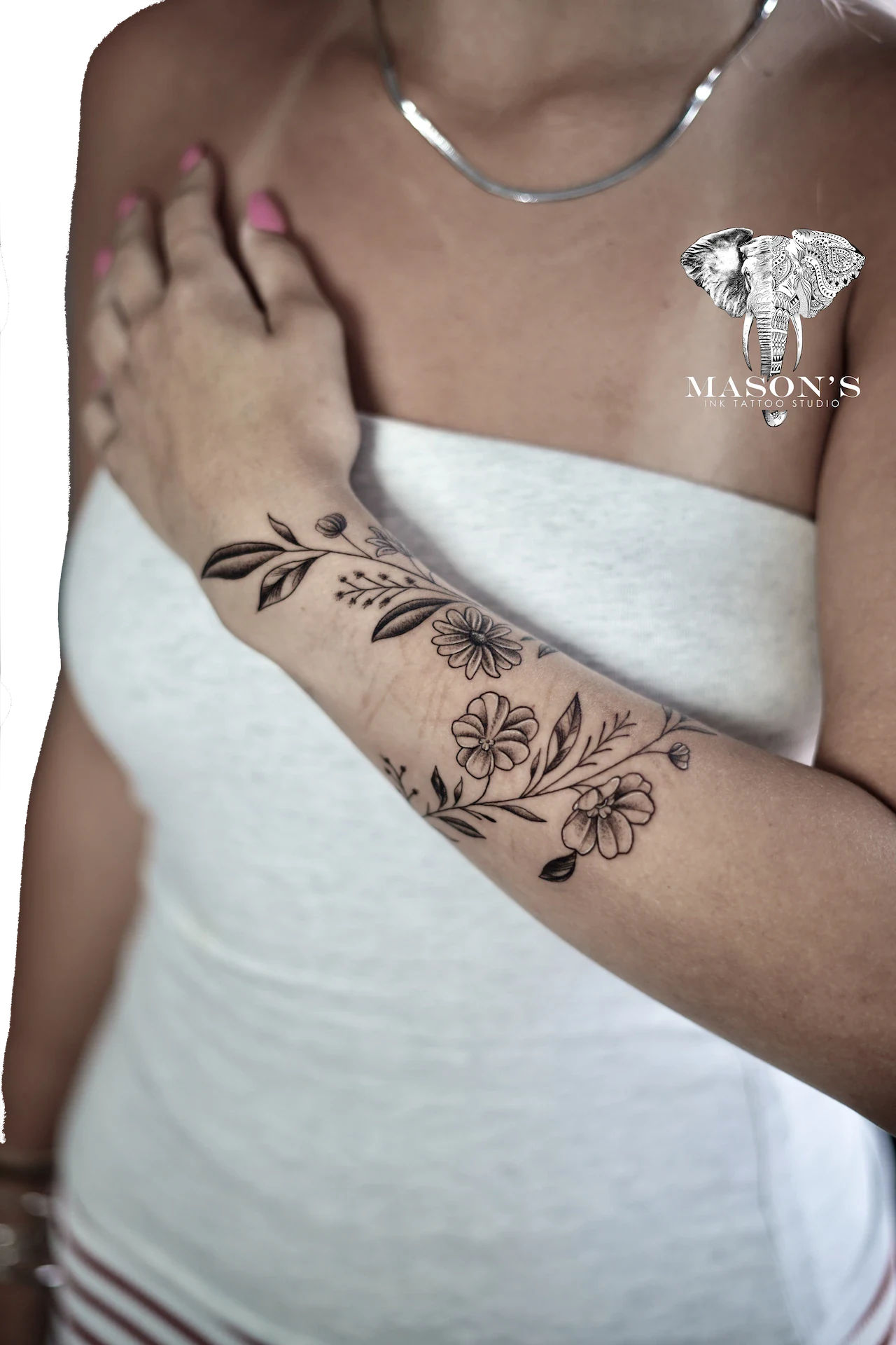 Floral Tattoo Design: a delicate floral design on the forearm