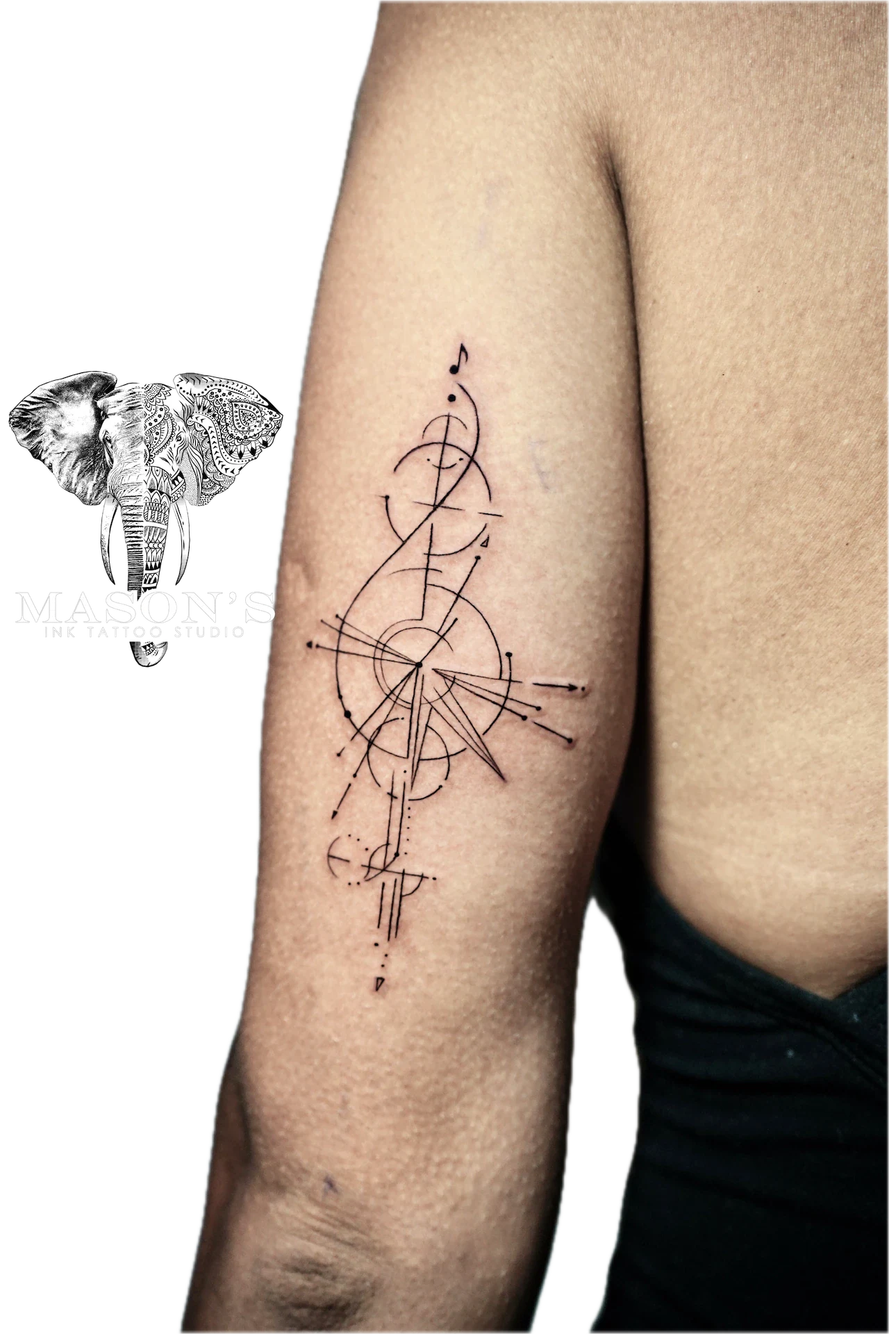 Geometric Tattoo Style Design: Minimal geometric pattern with musical note and compass on forearm