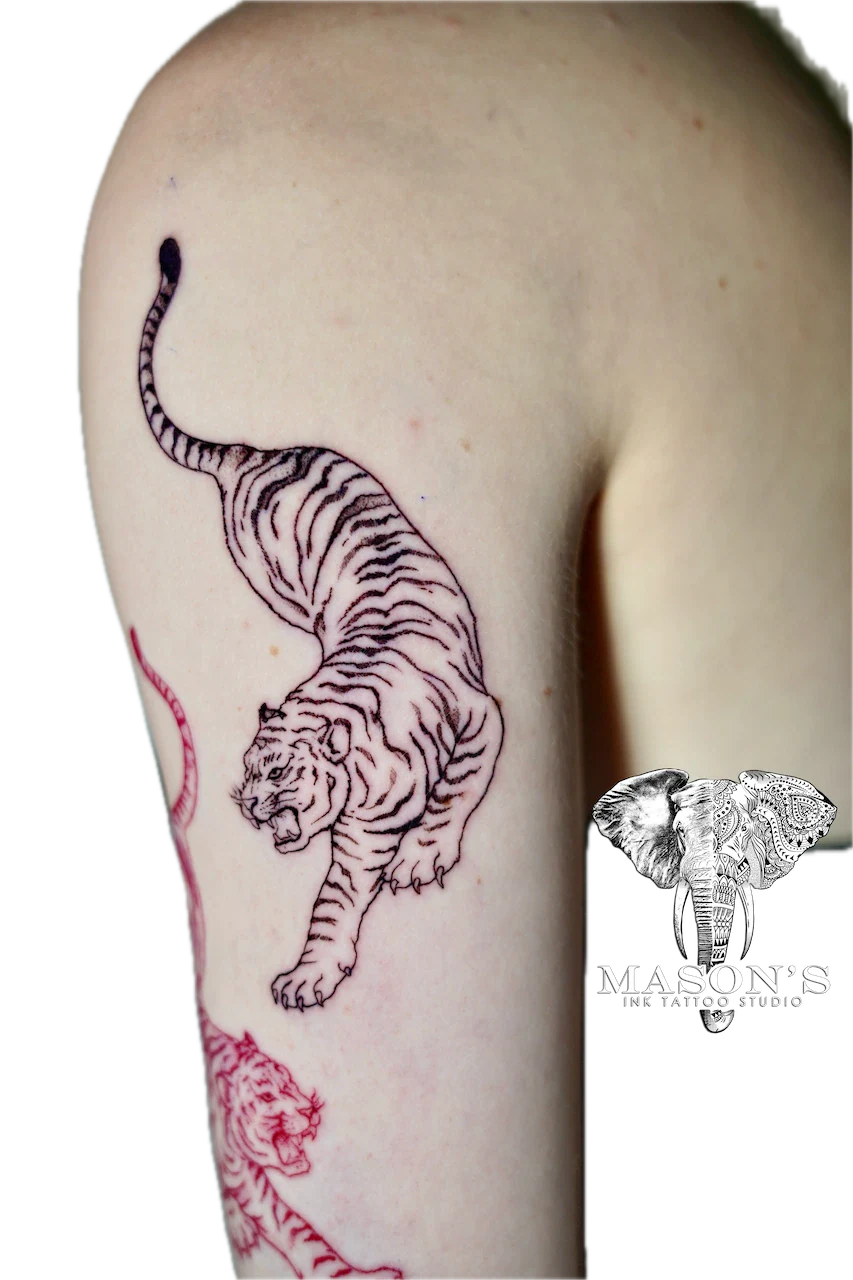 Japanese Tiger Tattoo Design: a detailed black and grey tiger tattoo on the upper arm