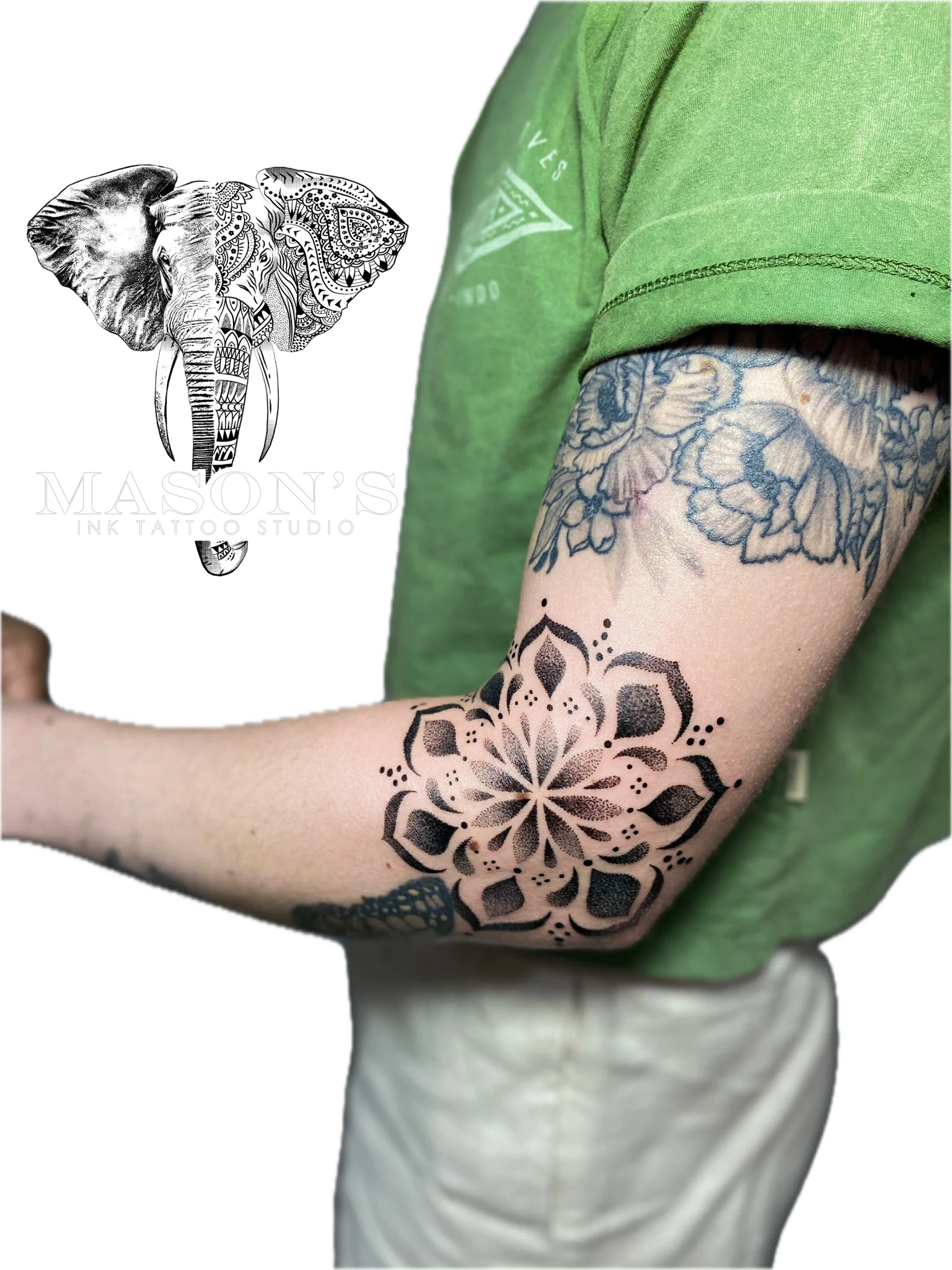 Mandala Tattoo Style Design: a large black and grey mandala with flowers and geometric patterns on the forearm