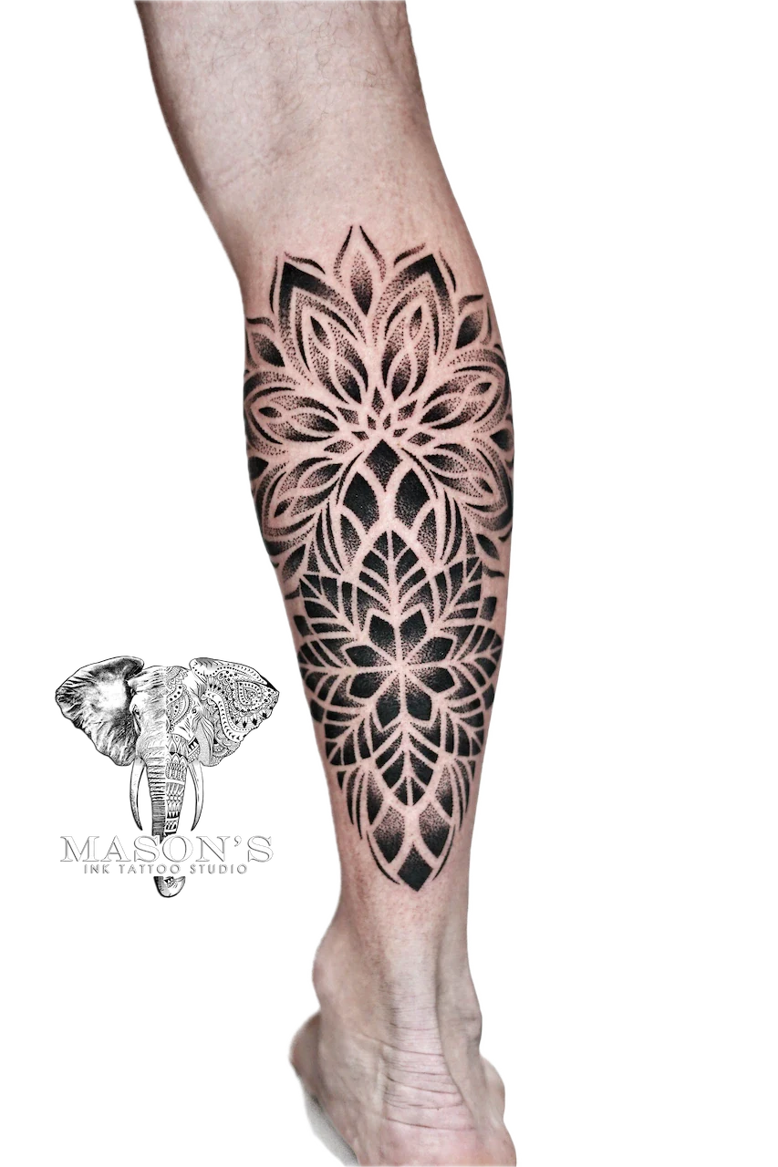 Mandala Tattoo Design: a large black and grey mandala pattern on a calf