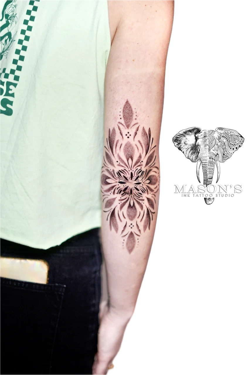 Ornamental Mandala Tattoo Design: a detailed mandala design with floral elements on the forearm