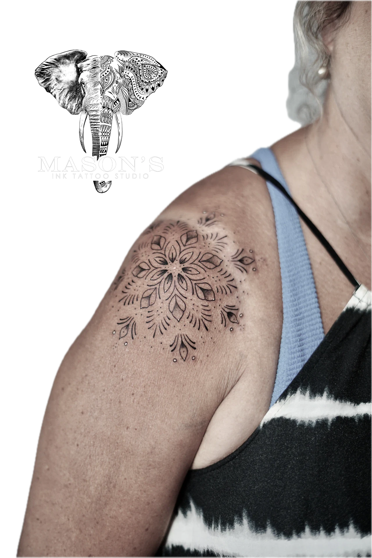 Mandala Tattoo Design: a detailed mandala with floral and eye motifs on the upper arm