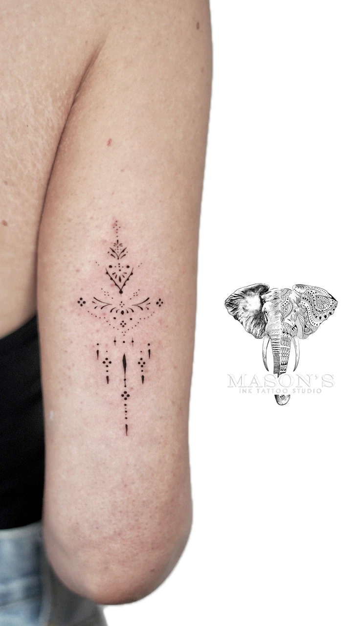 Ornamental Tattoo Design: a small minimalist mandala design on the forearm