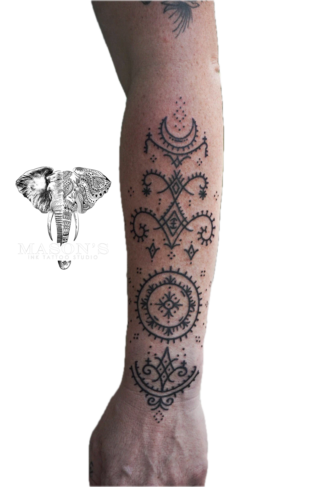 Ornamental Tattoo Style Design: a minimal geometric pattern with a moon and stars on a forearm