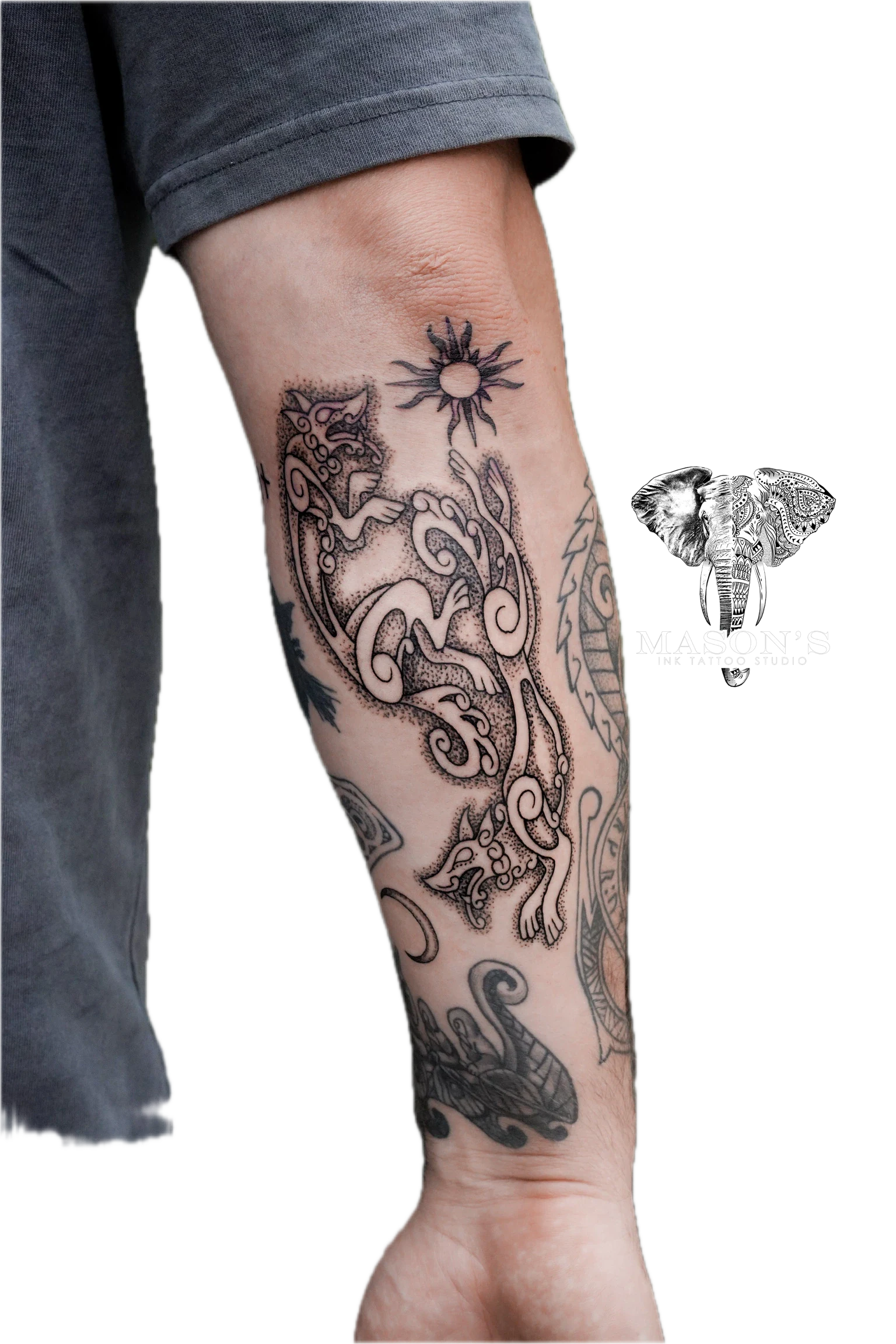 Ornamen Tattoo Style Design: a large forearm tattoo of a dragon and sun with intricate patterns