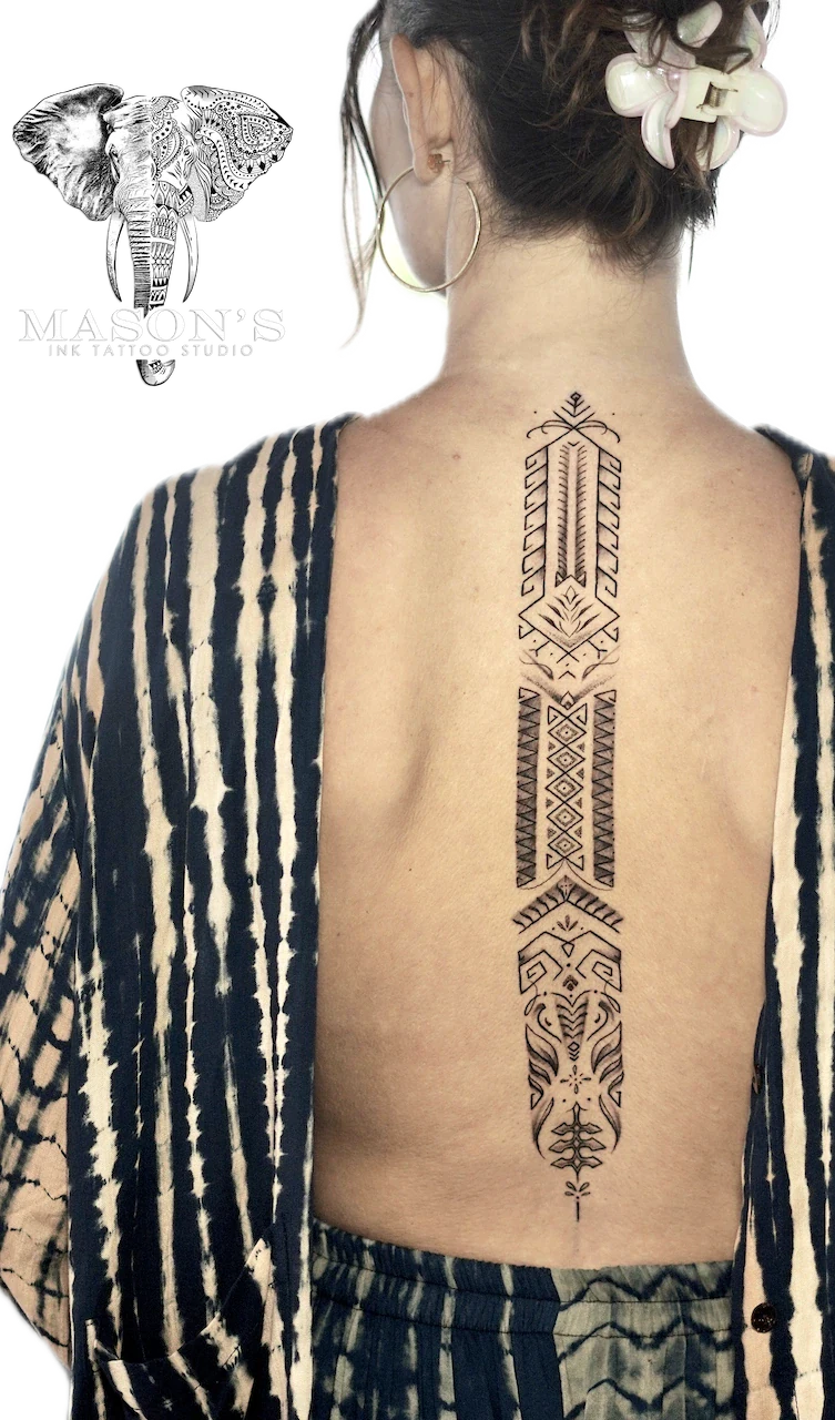 Ornamental Back Tattoo Design: a large geometric pattern tattoo running down the spine