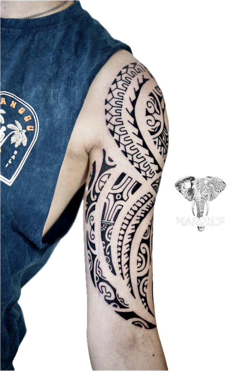 Polynesian Tattoo Design: a large black and grey geometric pattern and lettering tattoo on the upper arm