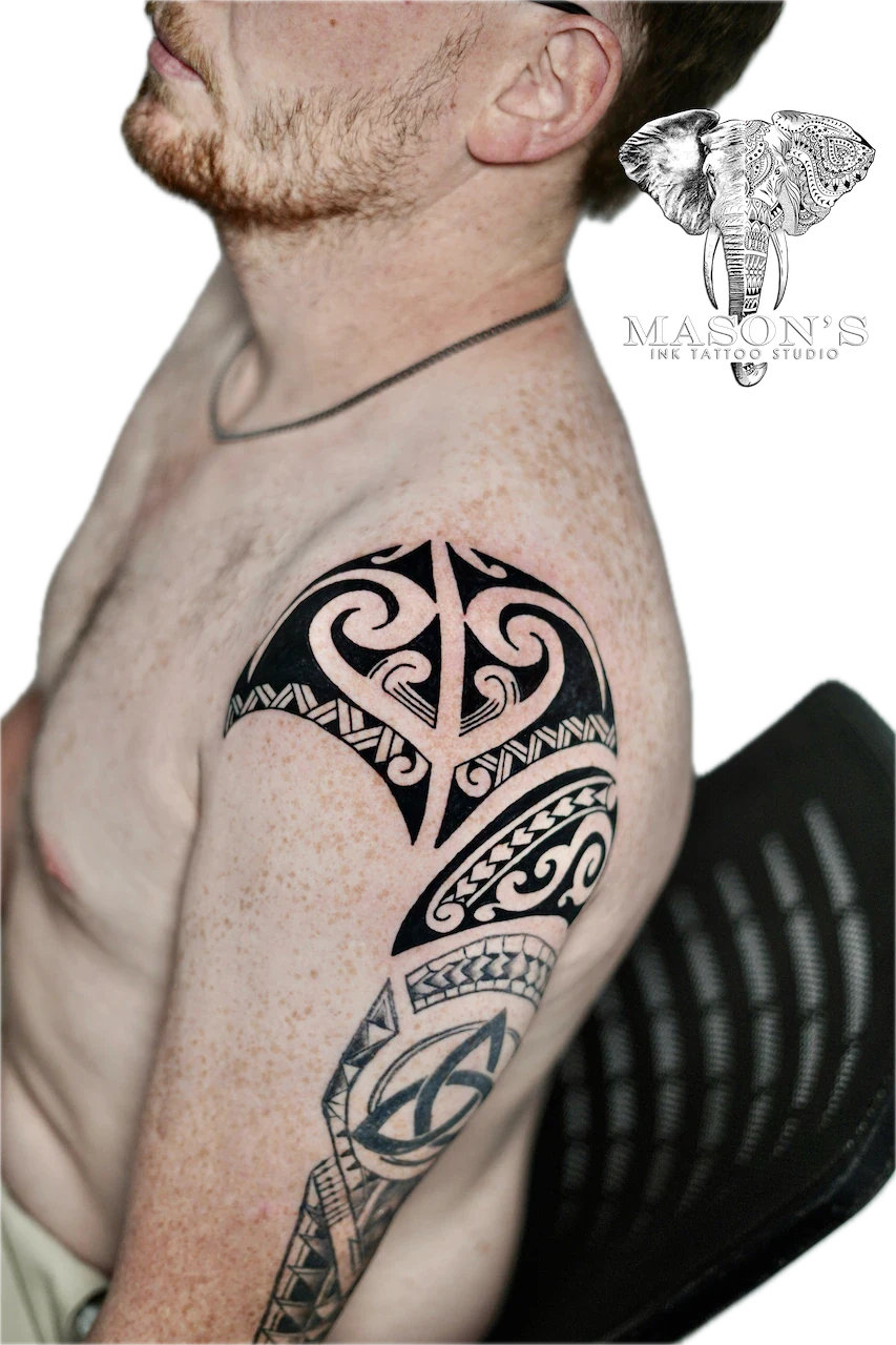 Authentic Polynesian Tattoo Design: a large black and grey geometric pattern tattoo on the upper arm