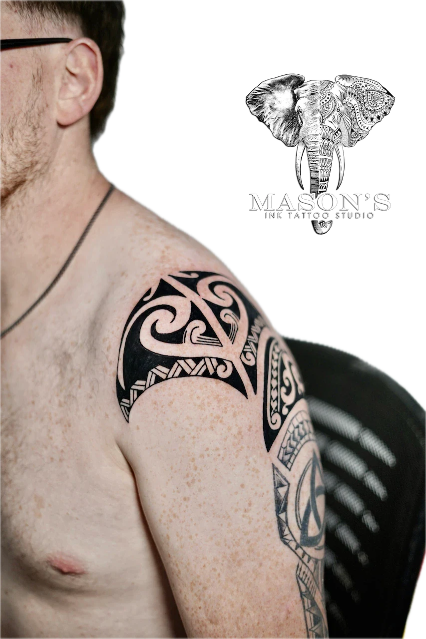 Polynesian Tribal Tattoo Design: a large black and grey geometric pattern on the upper arm