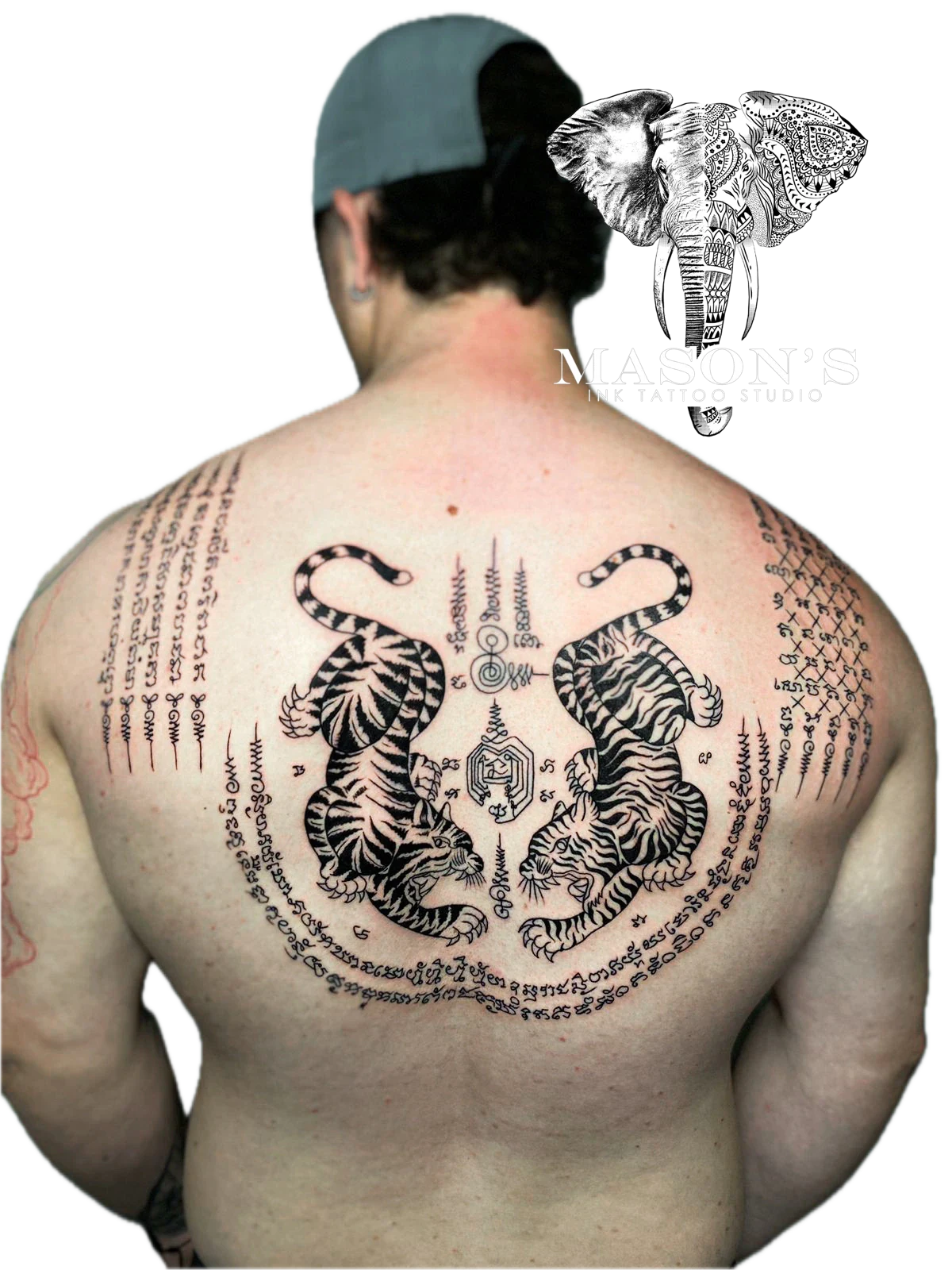 Sak Yant Tattoo Design: Two tigers and a mandala with lettering on a person's back