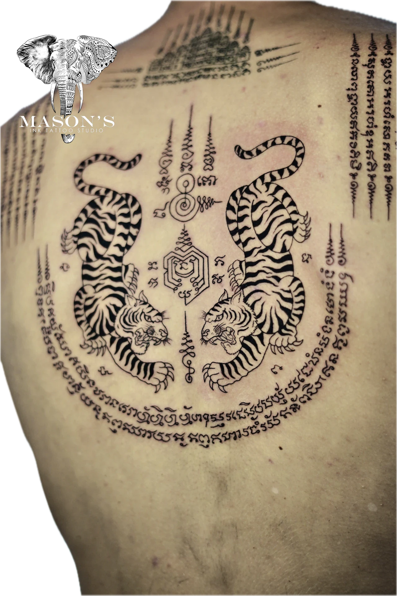 Sak Yant Tattoo Design: Two tigers with lettering and geometric patterns on the back